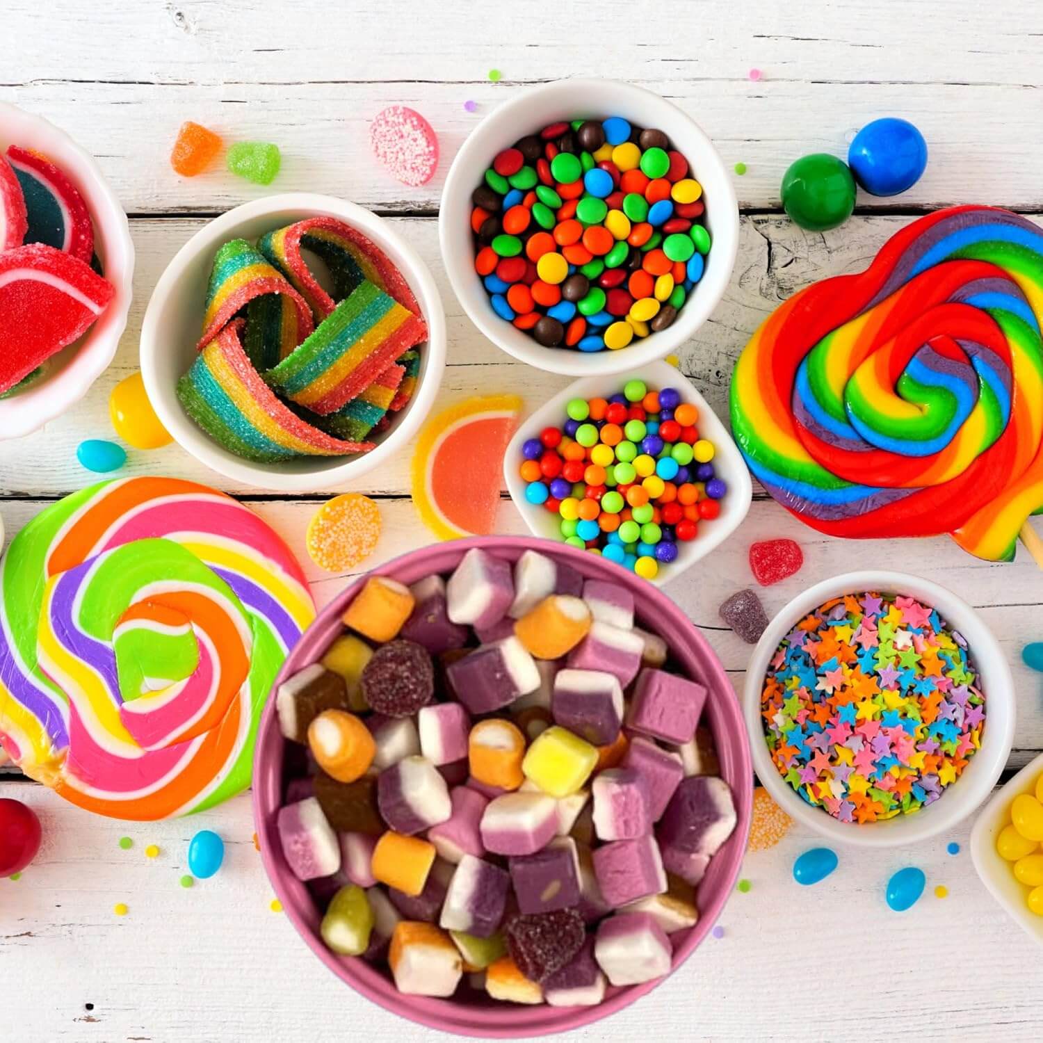 Assorted colorful candies on a wooden surface