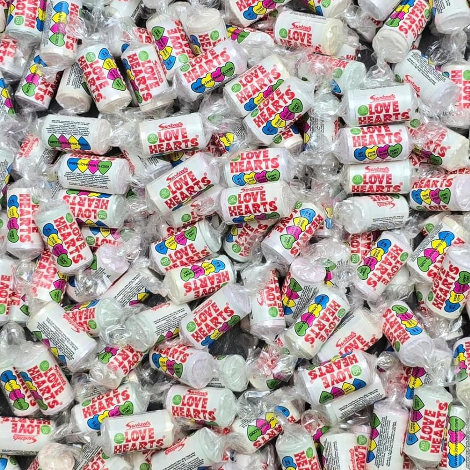 Close-up pile of Swizzels Love Hearts.