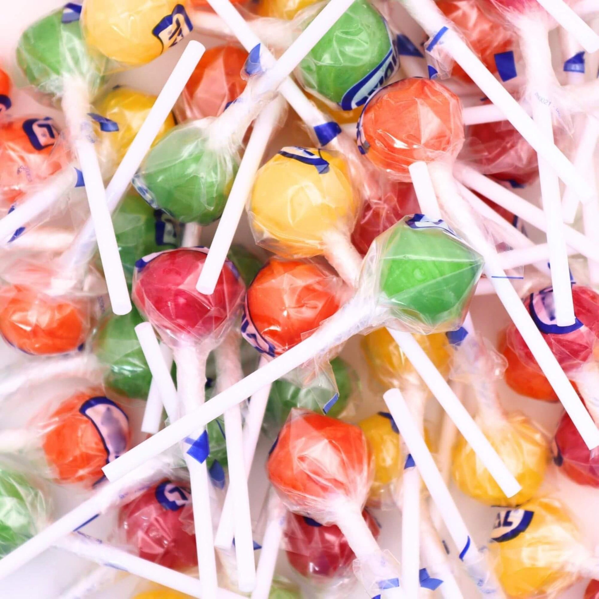 Assorted colorful lollipops on sticks with visible brand name.
