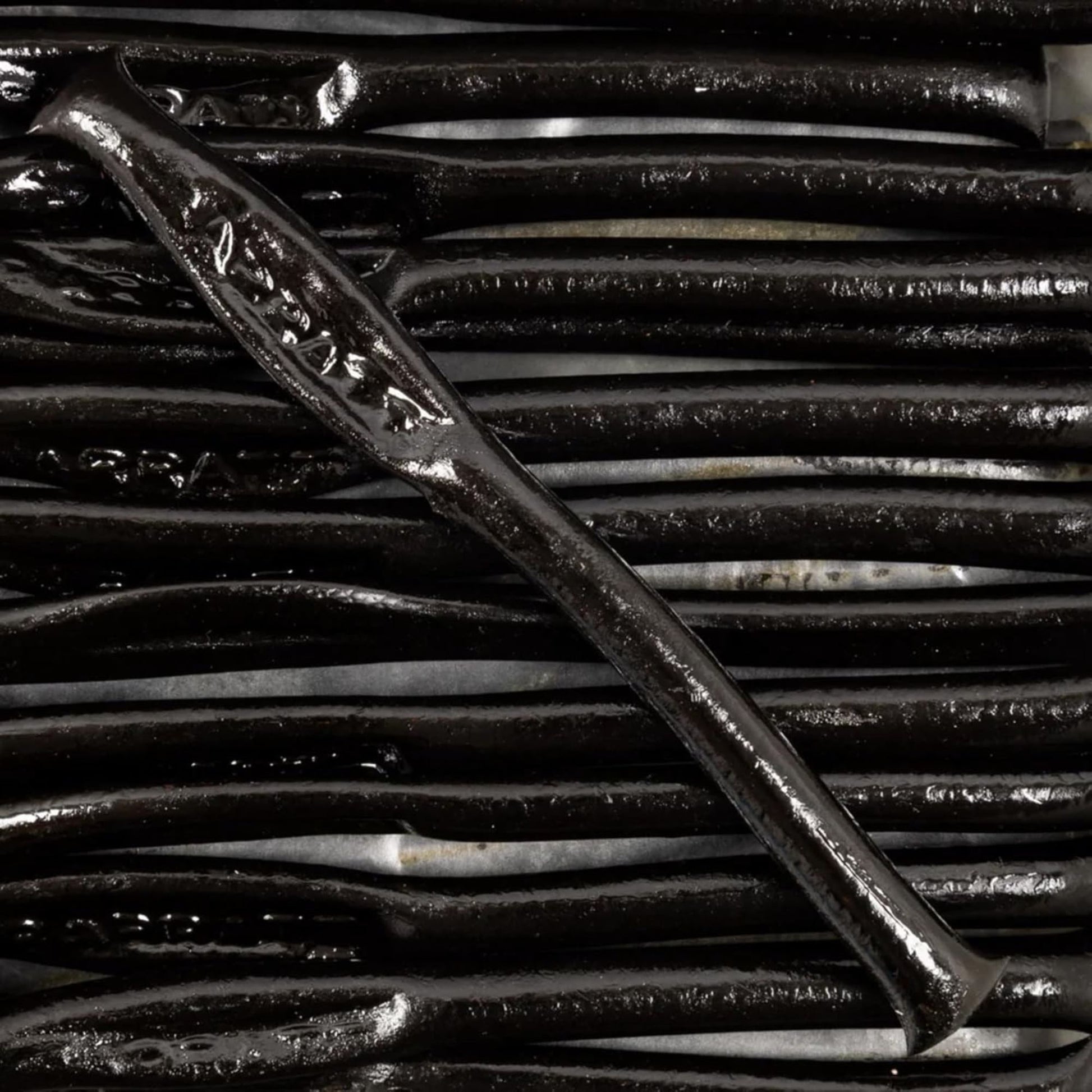 Close-up of a metal tool on a textured black background