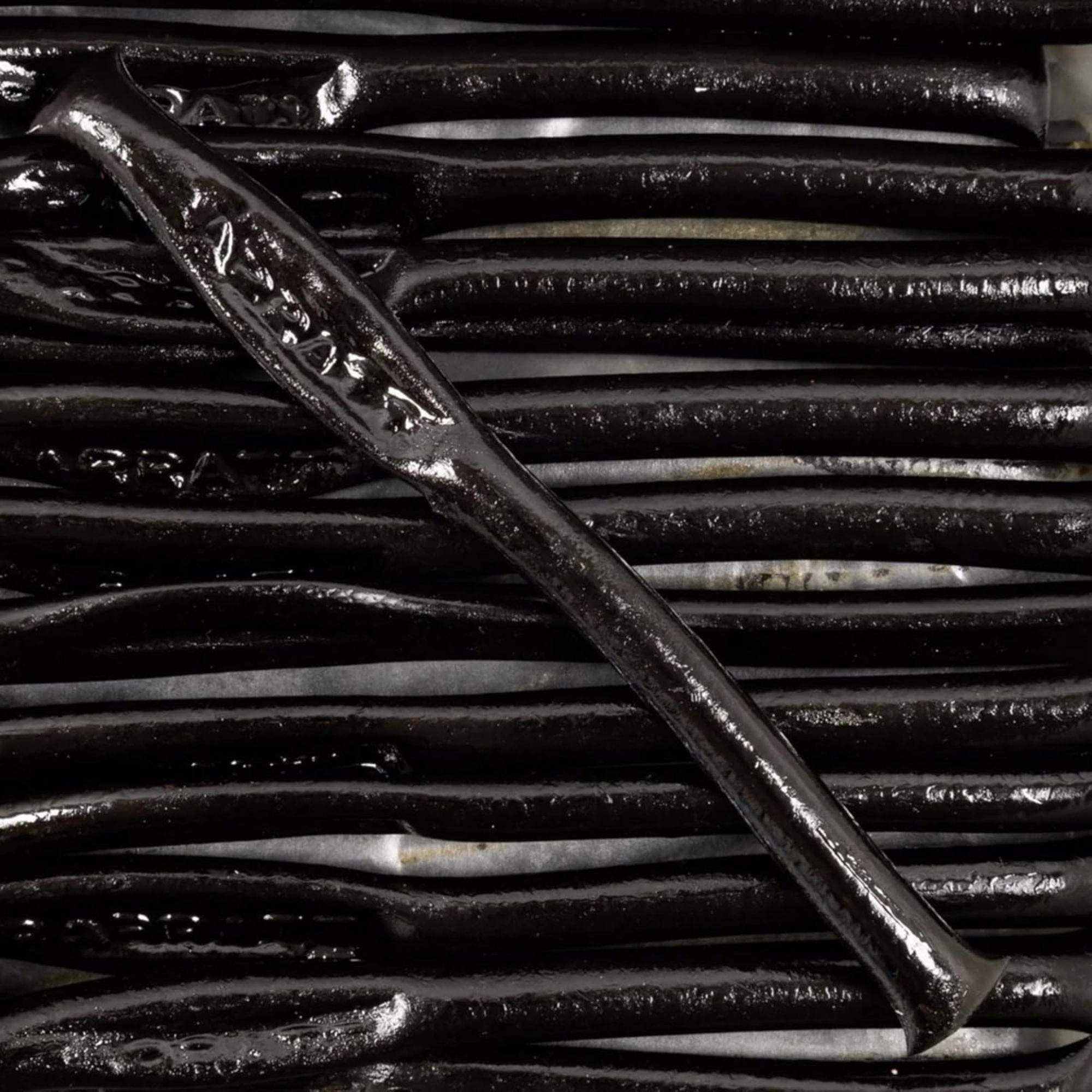 Close-up of a metal tool on a textured black background