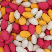 Assorted colorful jelly beans in pink, orange, and white.